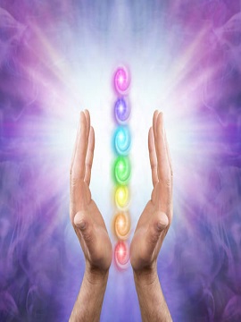 magnified1 Male parallel hands facing upwards against a purple magenta background of radiating energy and the Seven Chakras floating between his hands